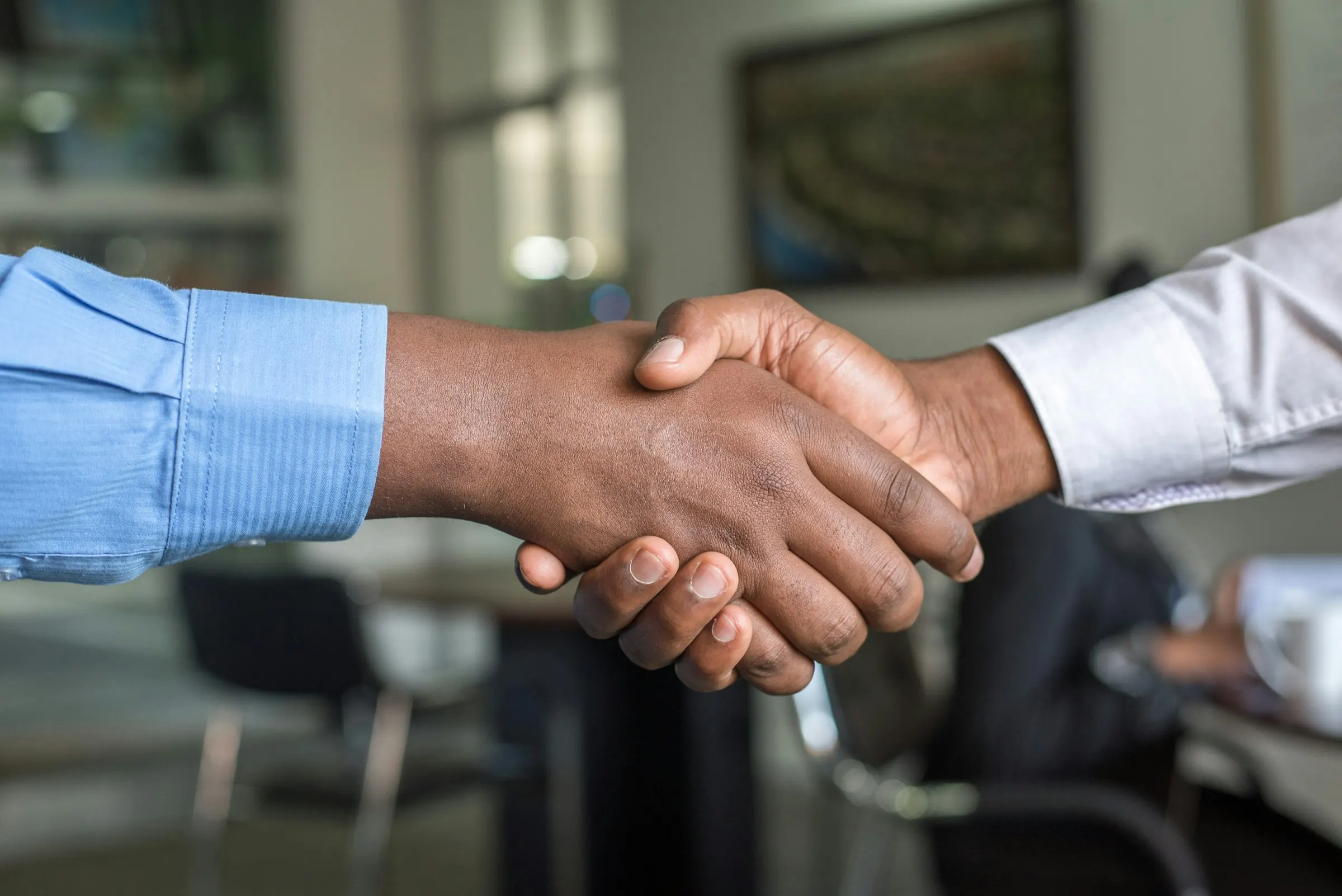 Business partnership handshake for Sterling channel partner application